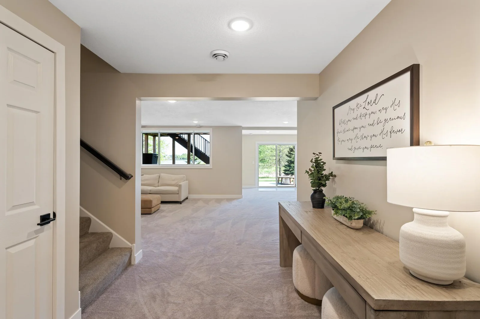 Finished in 2024, the lower level offers a walk-out to a stamped, concrete patio, fifth bedroom, storage, and a 3/4 bath.