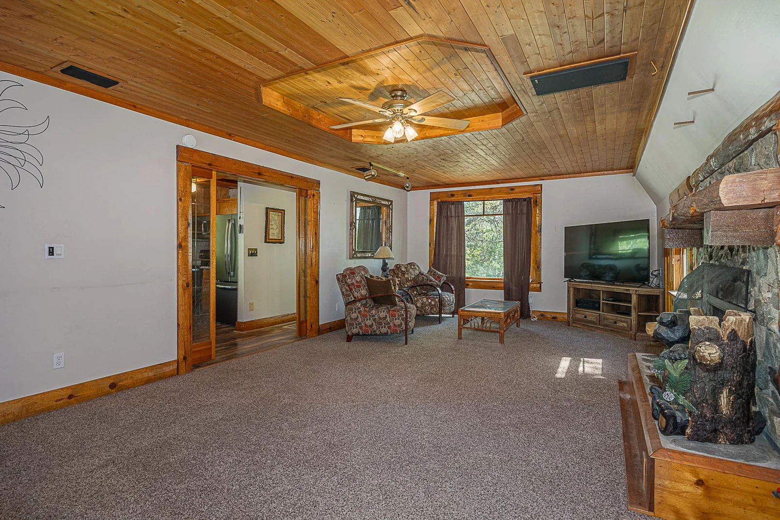 View of living room with a fireplace.