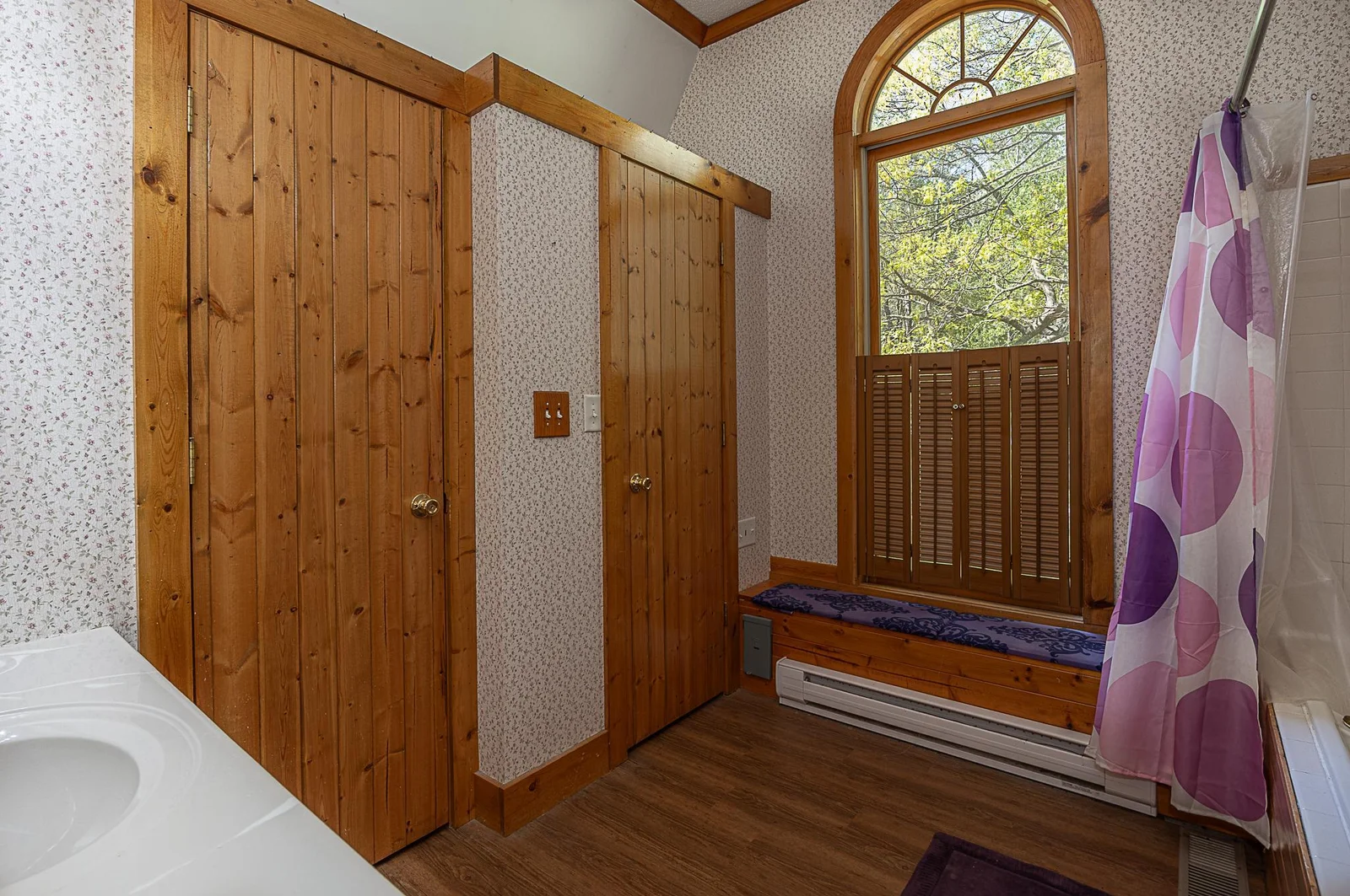 Primary suite bathroom with vaulted ceiling.