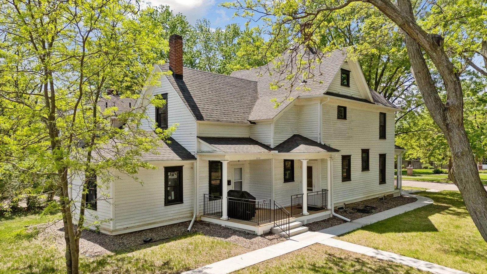 Another beautiful porch on the side of the home with the entrance to the Accessory Dwelling Unit as well as the primary unit kitchen.