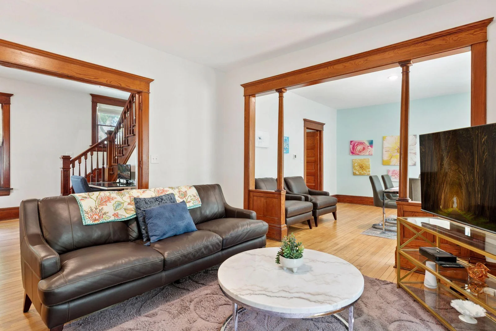 This beautifully preserved Victorian living space features rich original woodwork, elegant columns and seamless flow between formal living and dining areas.