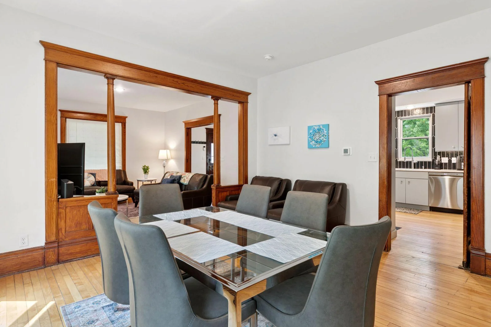 Gracious dining setting with beautifully preserved Victorian woodwork, and through the kitchen door is a beautiful modern kitchen!
