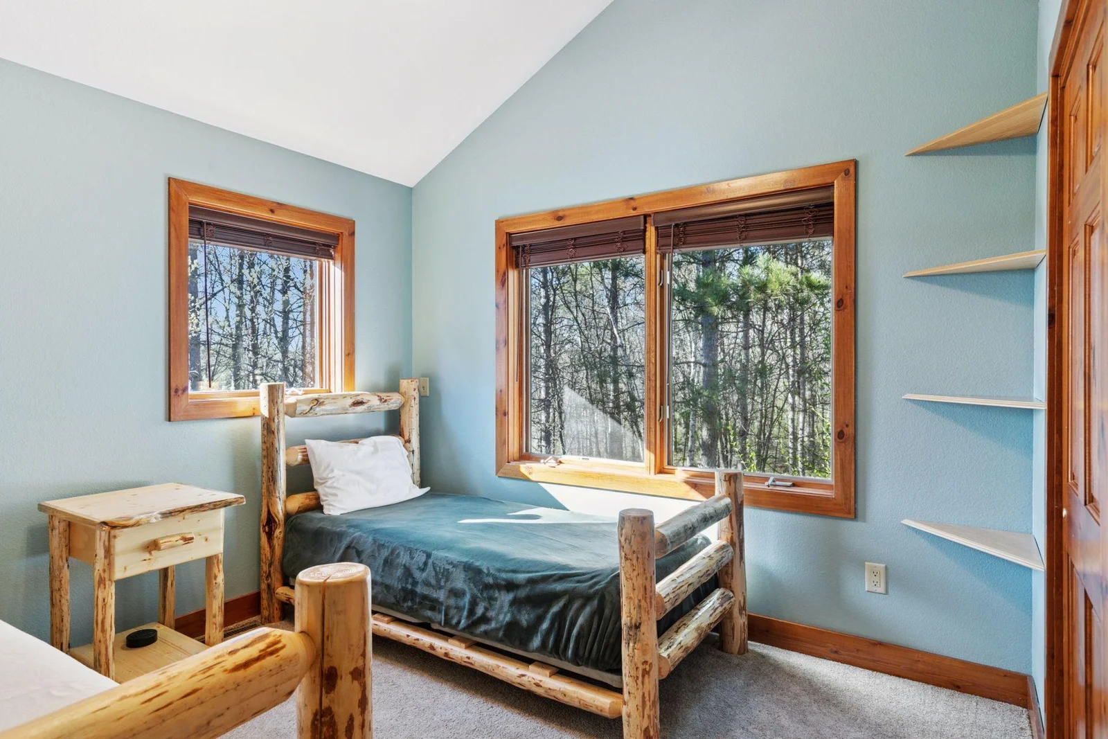 Upper bedroom with vaulted ceilings, currently set up to sleep four