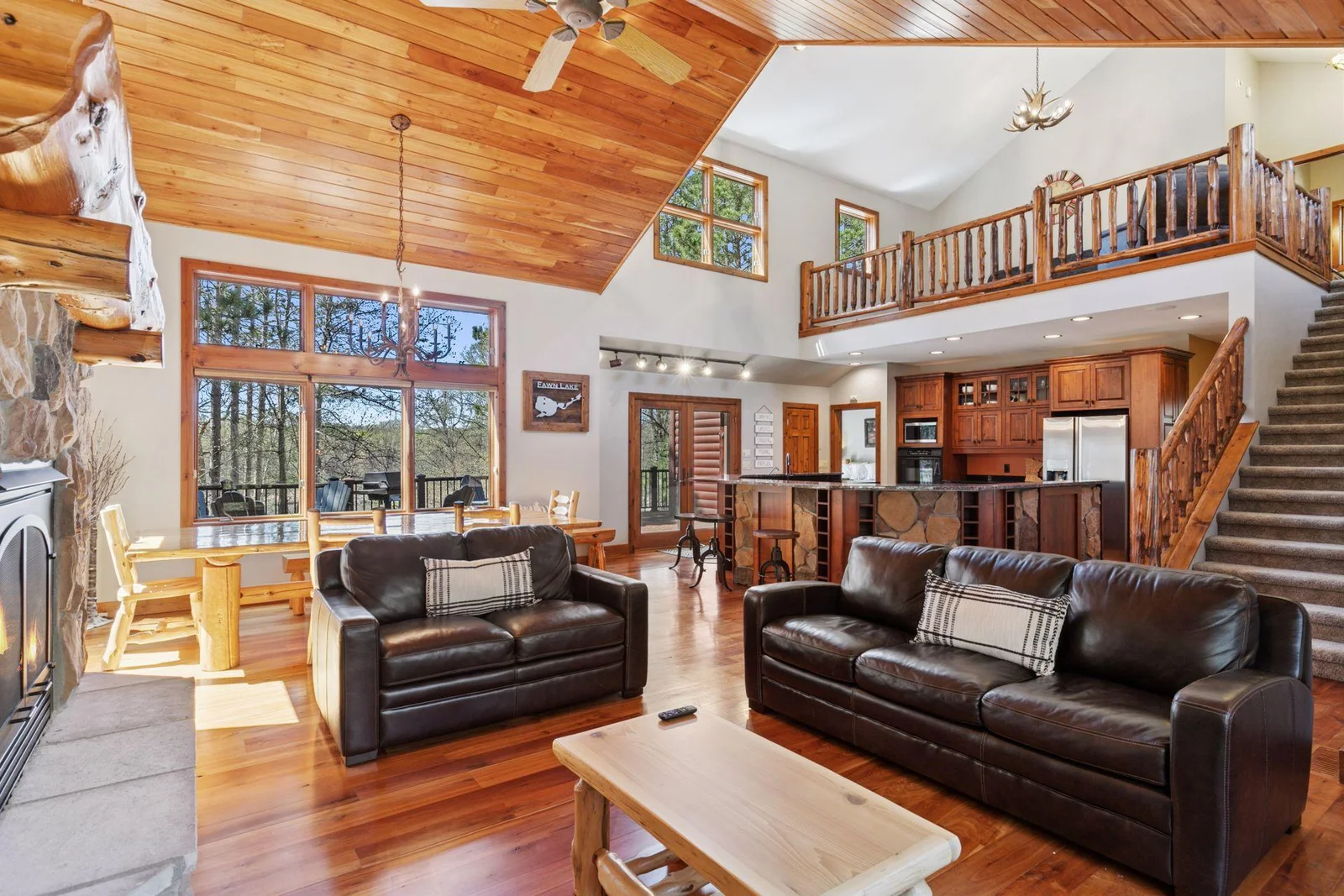 Hardwood floors, cathedral ceilings, wall fo windows for natural light and incredible lake views