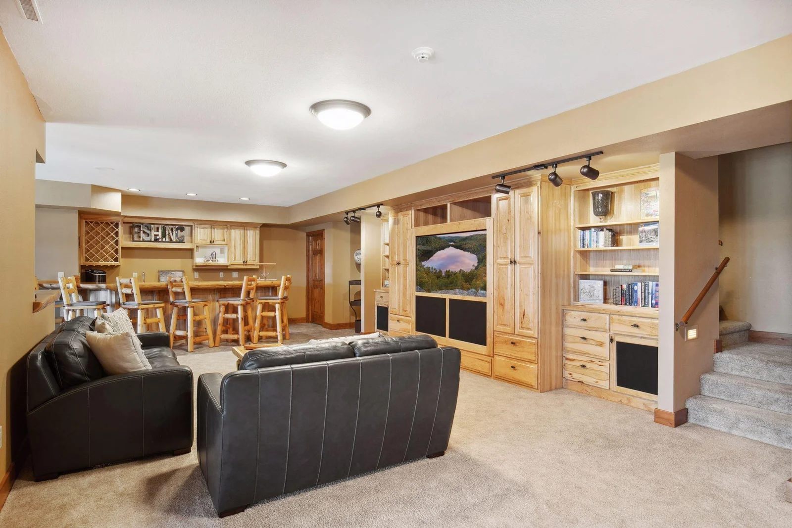 Lower level entertainment space with built-ins and wetbar