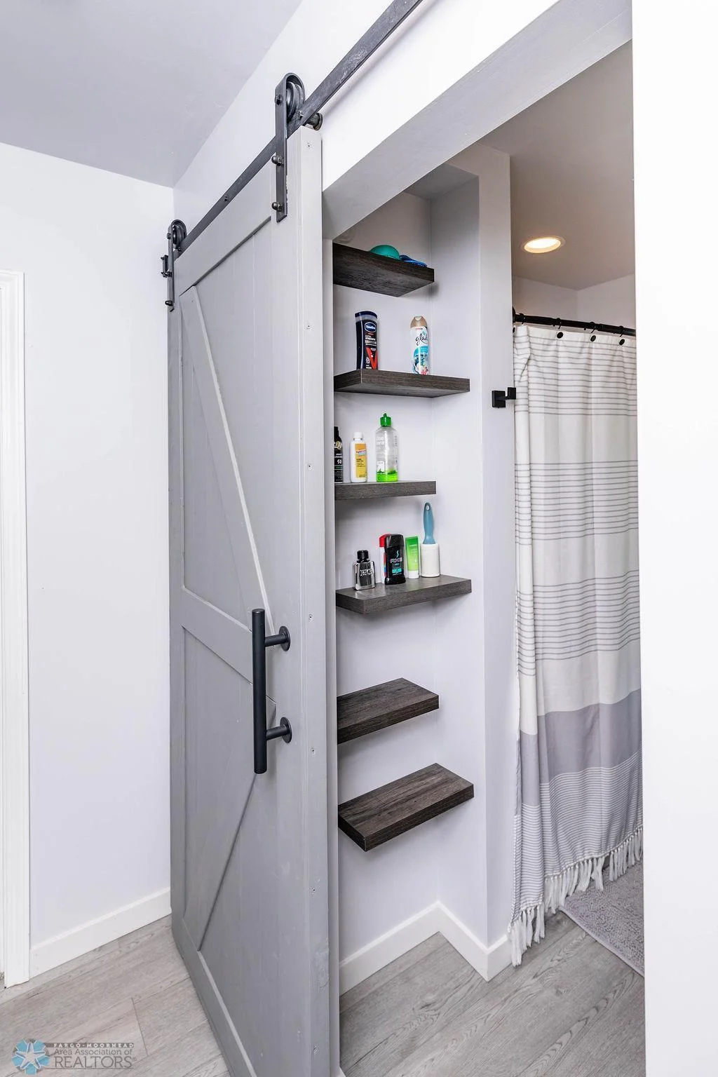 Bathroom storage. Door slides to reveal hallway linen closet