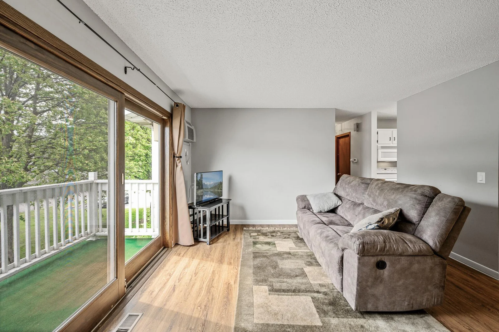 Living room with tons of natural light from deck, and new LVP flooring!