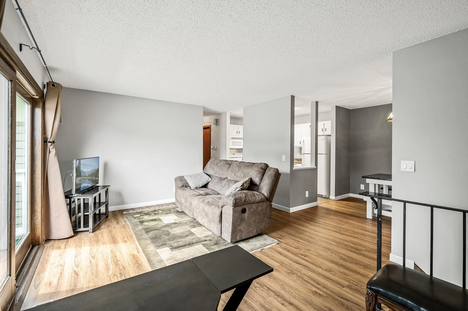 Living room with tons of natural light from deck doors, and new LVP flooring!