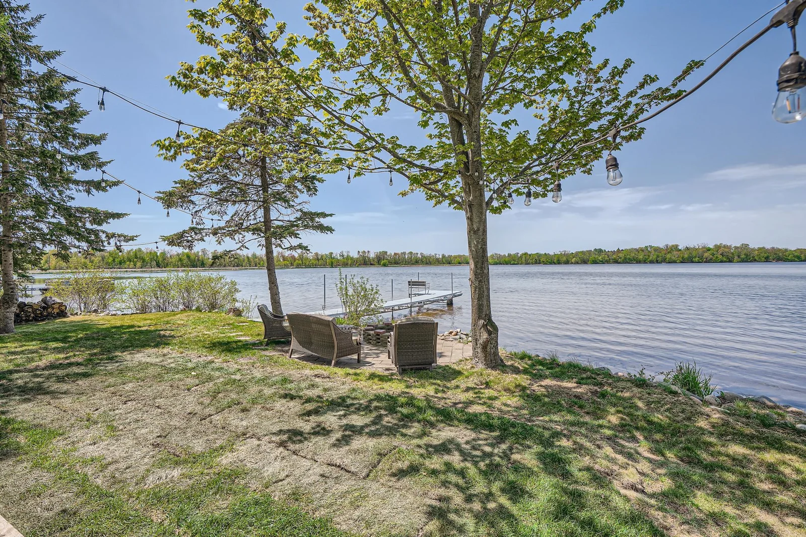 Private dock and lakeside patio with a fire pit.