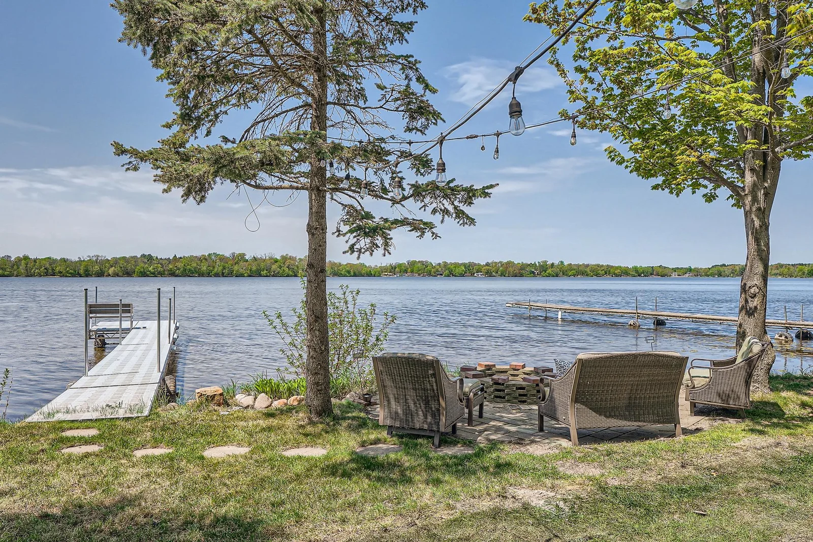 Private dock and lakeside patio with a fire pit.