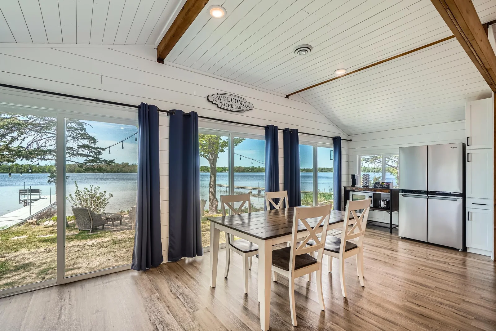 Lake-facing dining area offers an abundance of natural light, and direct access to your backyard and dock—perfect for indoor-outdoor entertaining.