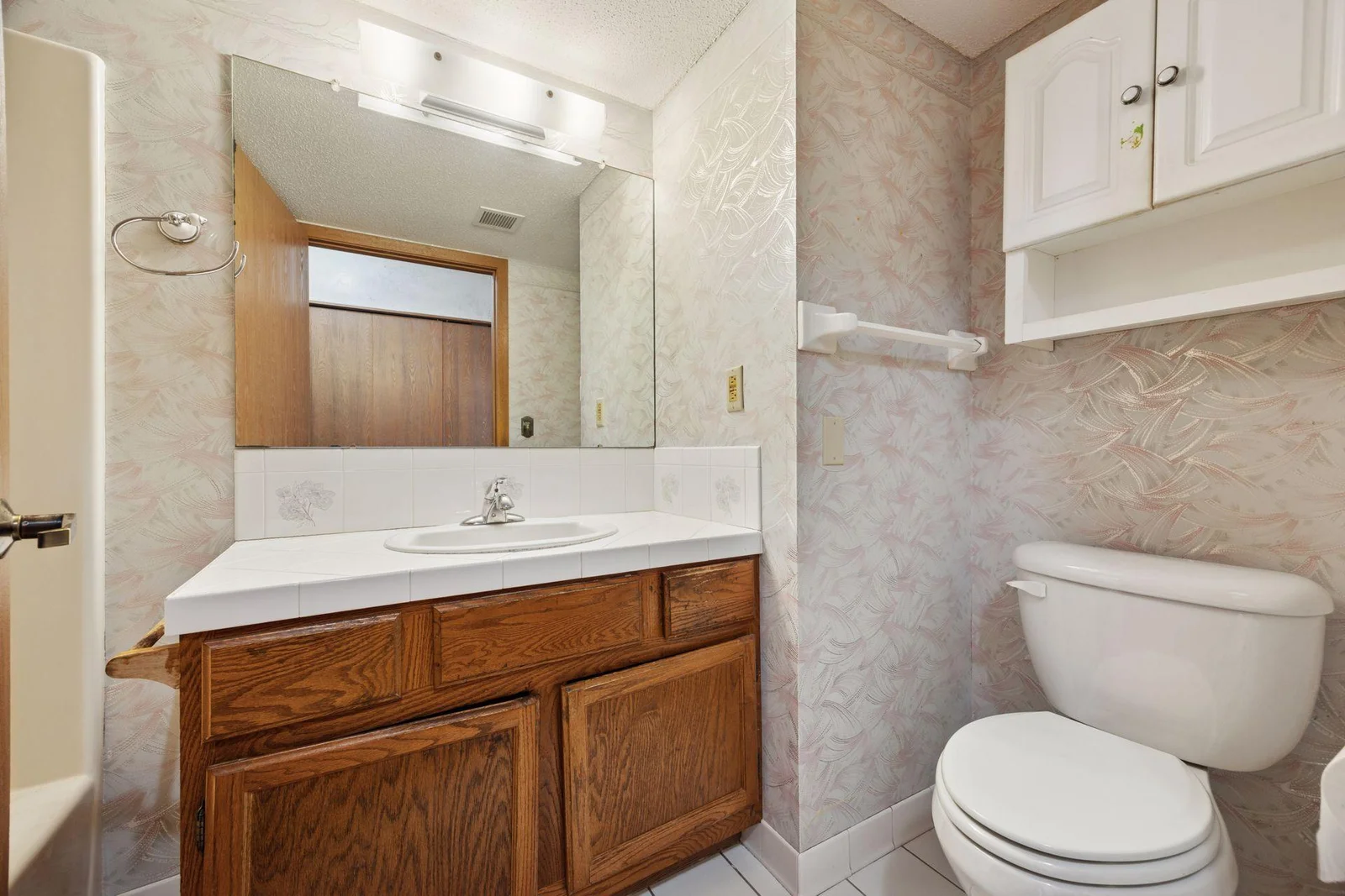 Full bathroom with tile floor, sink top and back splash