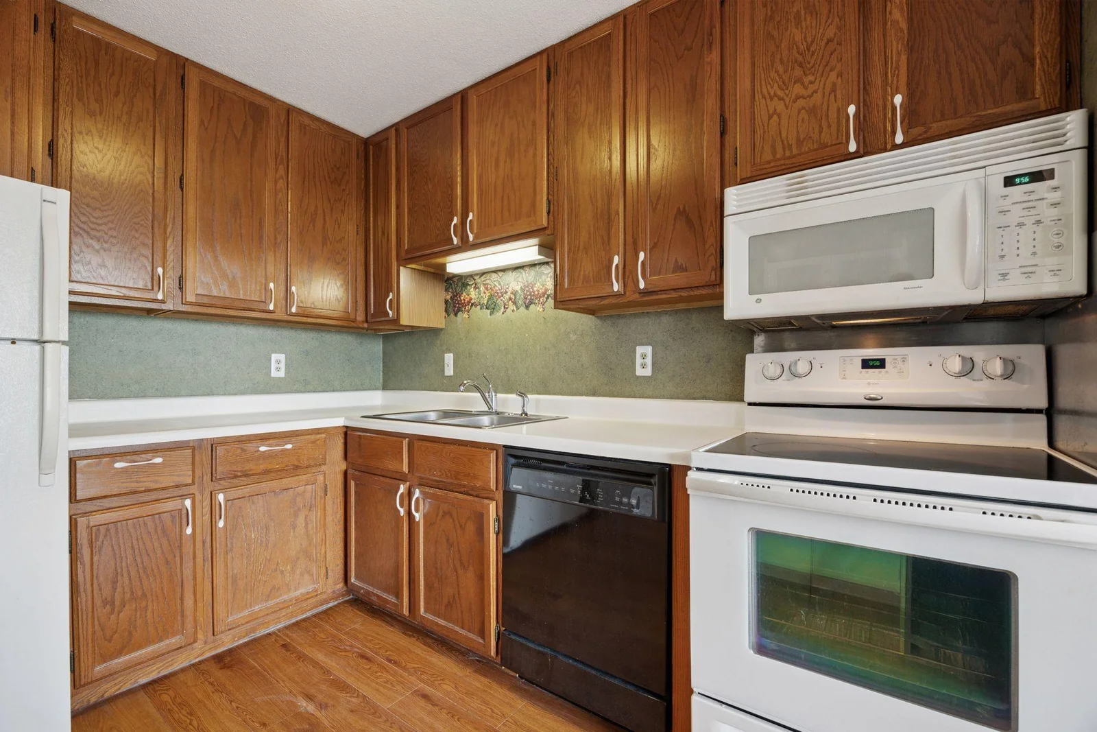 Large eat in kitchen with lots of cabinets, some newer appliances and vinyl flooring