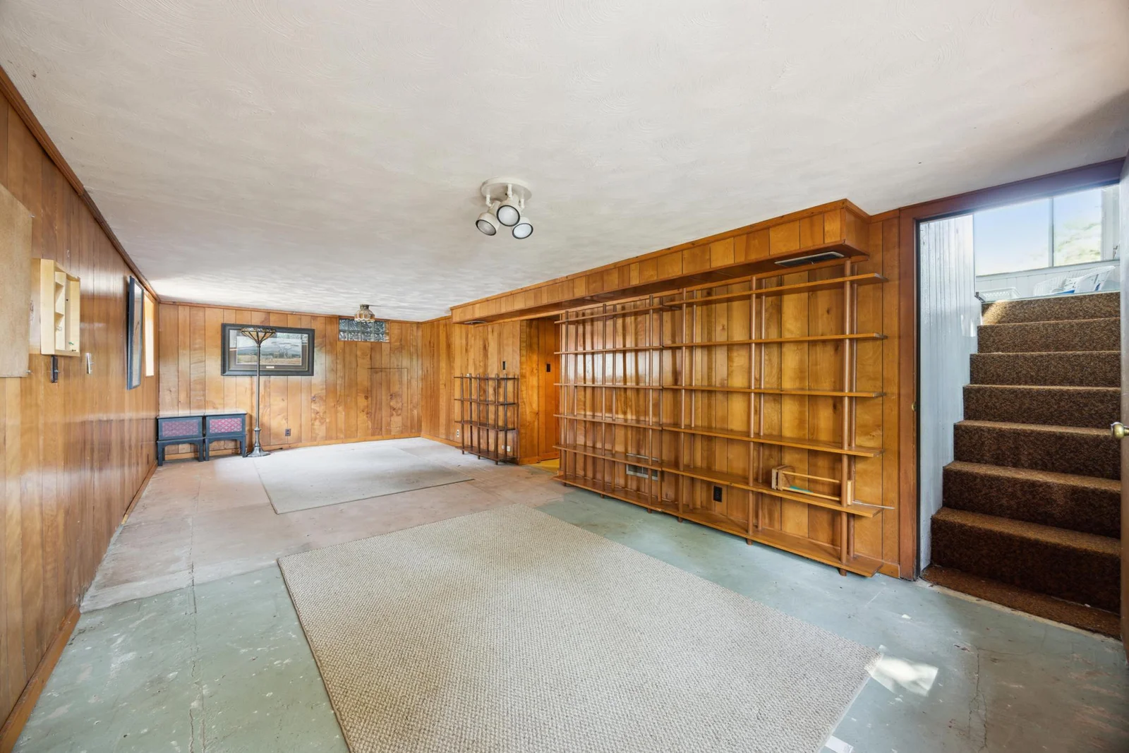 Lower level with family room. Stairs to the right lead to the porch that has patio doors leading to the lake.