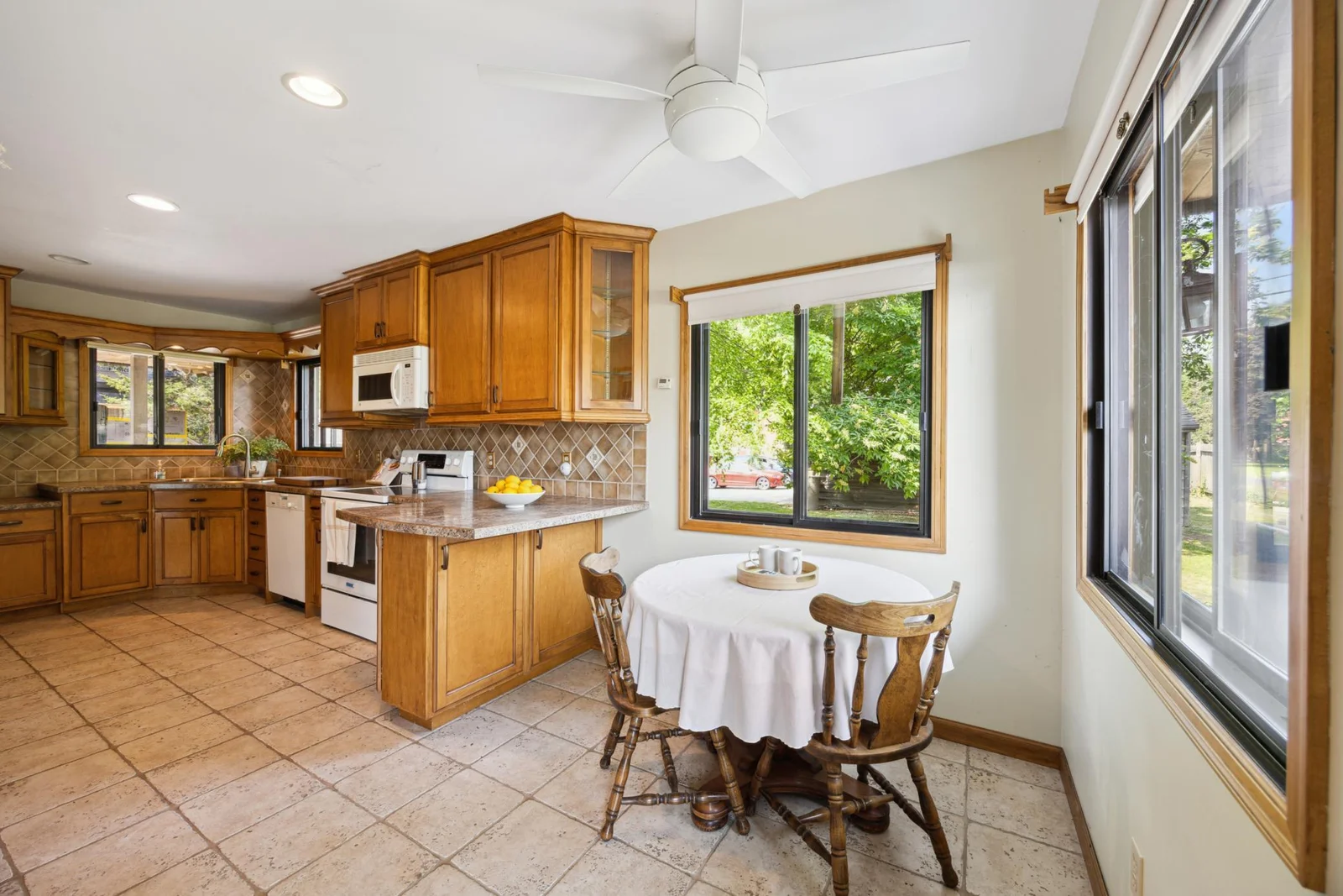 Kitchen with informal dining space.  Cabinets and drawers abound in this kitchen.  Again  lots of windows allowing natural light.