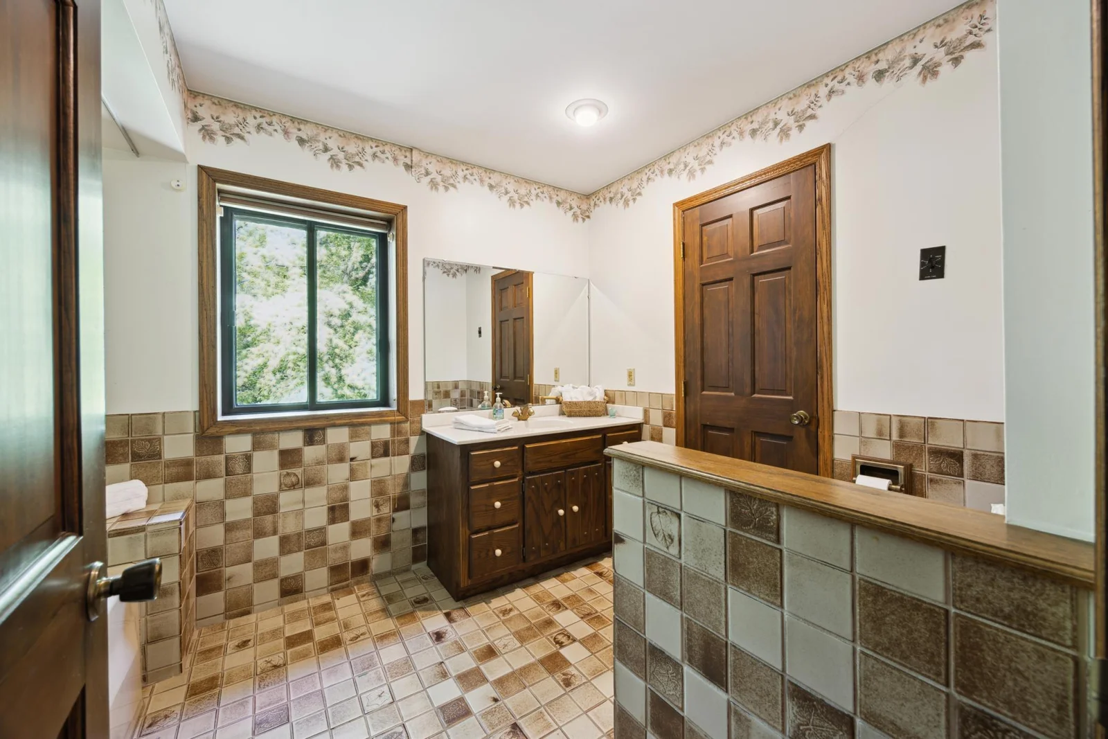 The bathroom that leads to the laundry through the door on the right.  Jetted tub is on the left of this photo.