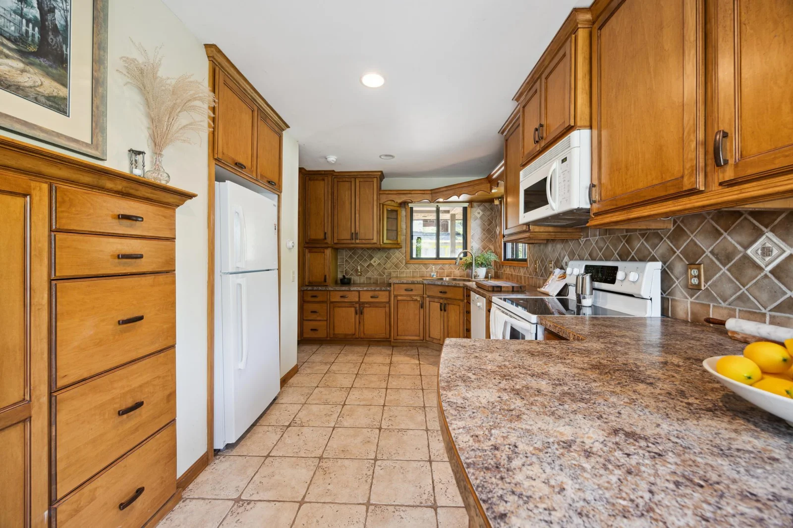 Another photo of the kitchen showing the added cabinets on the other side of the counter and next to the refrigerator.