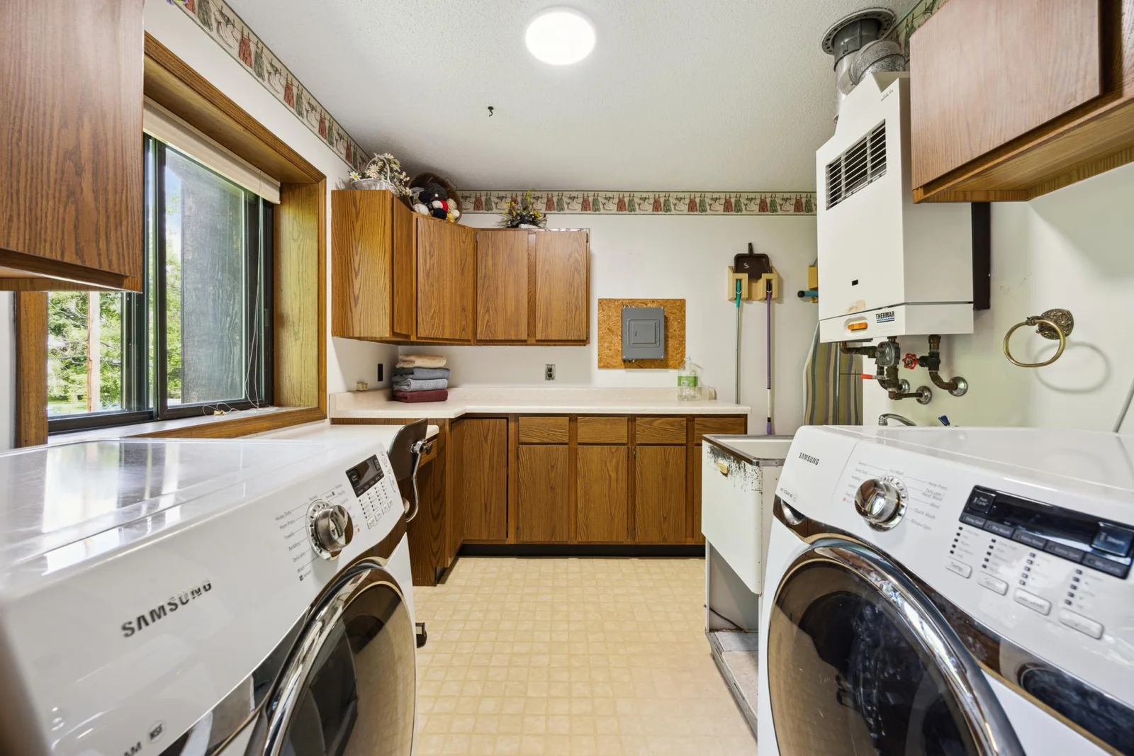 This is the laundry room with plenty of space and cabinets.  Through the doorway where this photo was taken is another bath with jetted tub