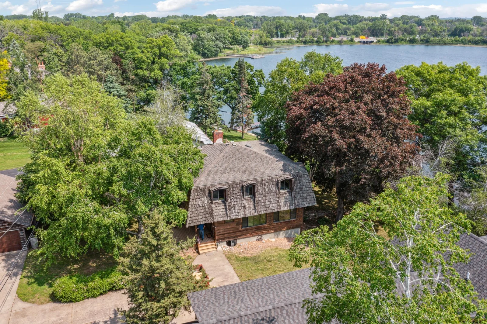 The roof is asphalt shingles surrounded by cedar shakes.