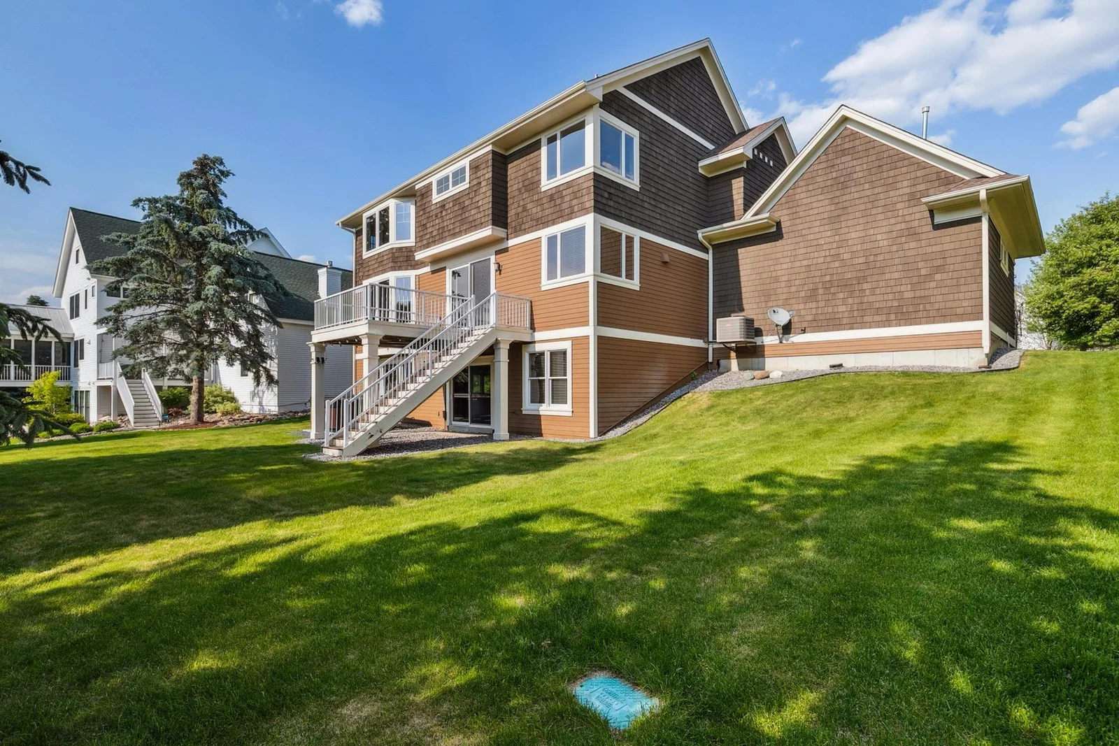 Beautifully landscaped backyard offers both privacy and plenty of space for outdoor fun.