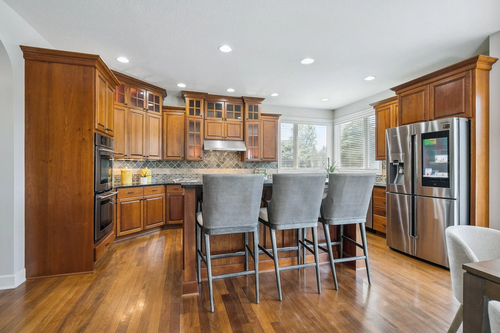 Gourmet kitchen featuring rich solid cherry wood cabinetry and upscale stainless steel appliances.