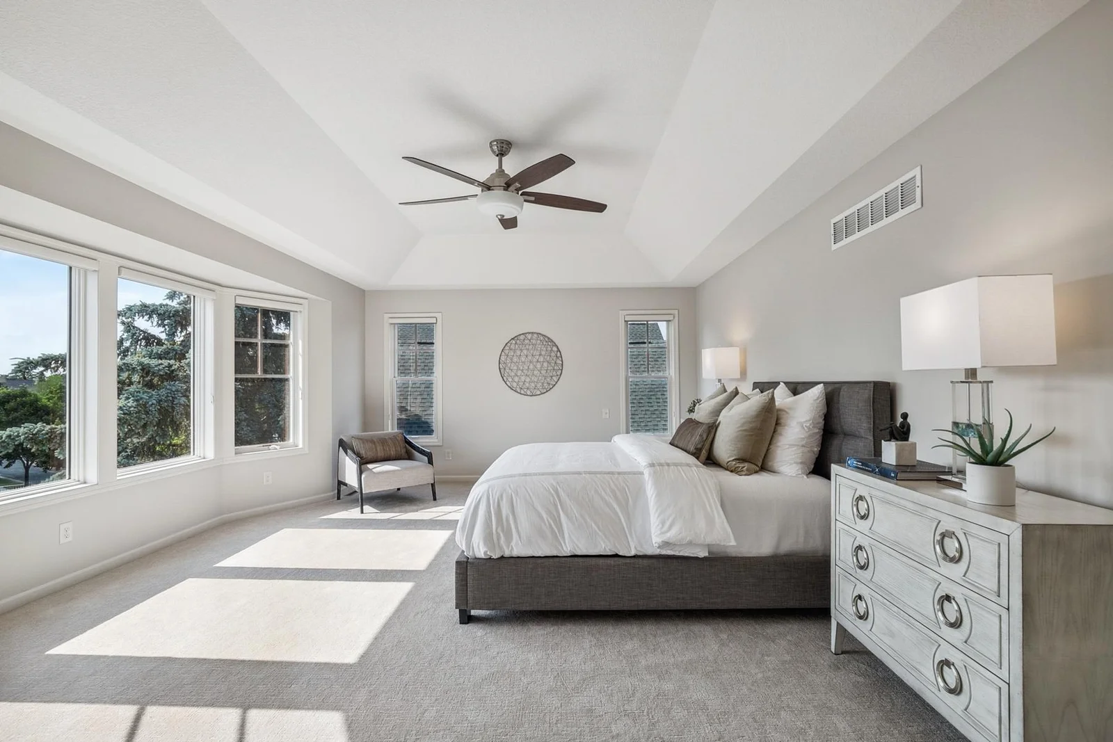 Spacious primary suite flooded with natural light—a peaceful retreat to unwind.