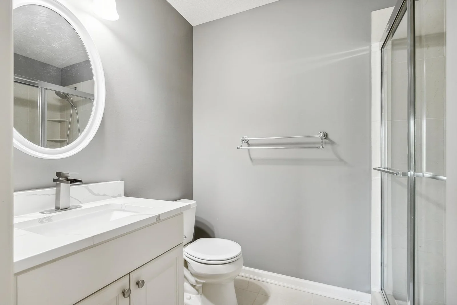 Comfortable upper-level bedroom perfect for guests or family, featuring a convenient private bath.