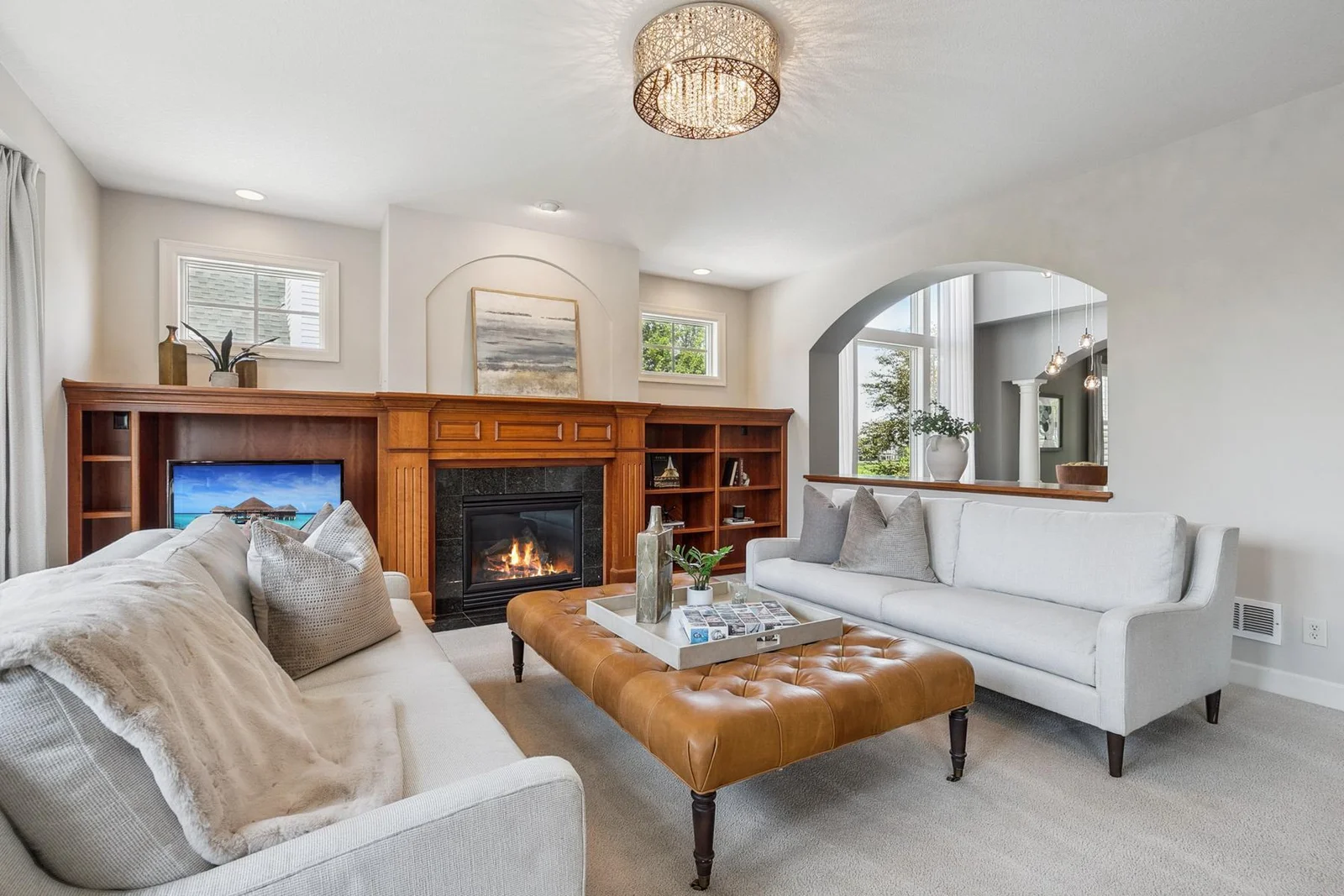 Cherry wood accents and soft natural light make this living room feel like home.