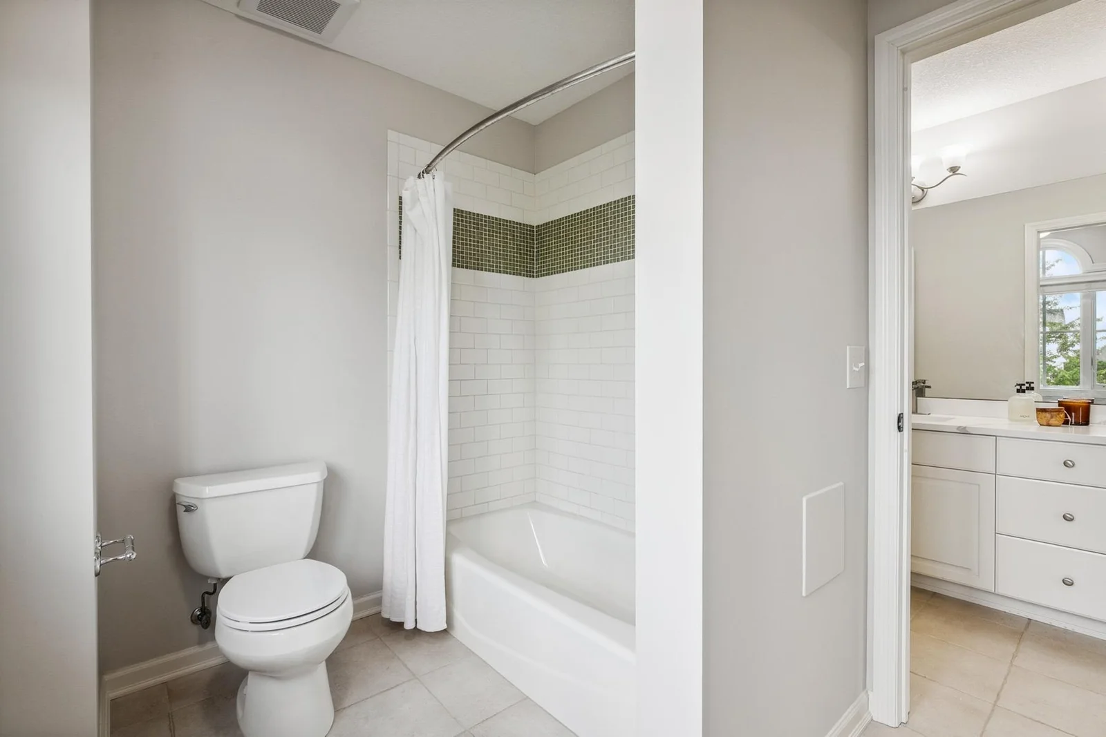 Elegant bathroom design with a separate tub and private toilet area for added comfort and privacy.