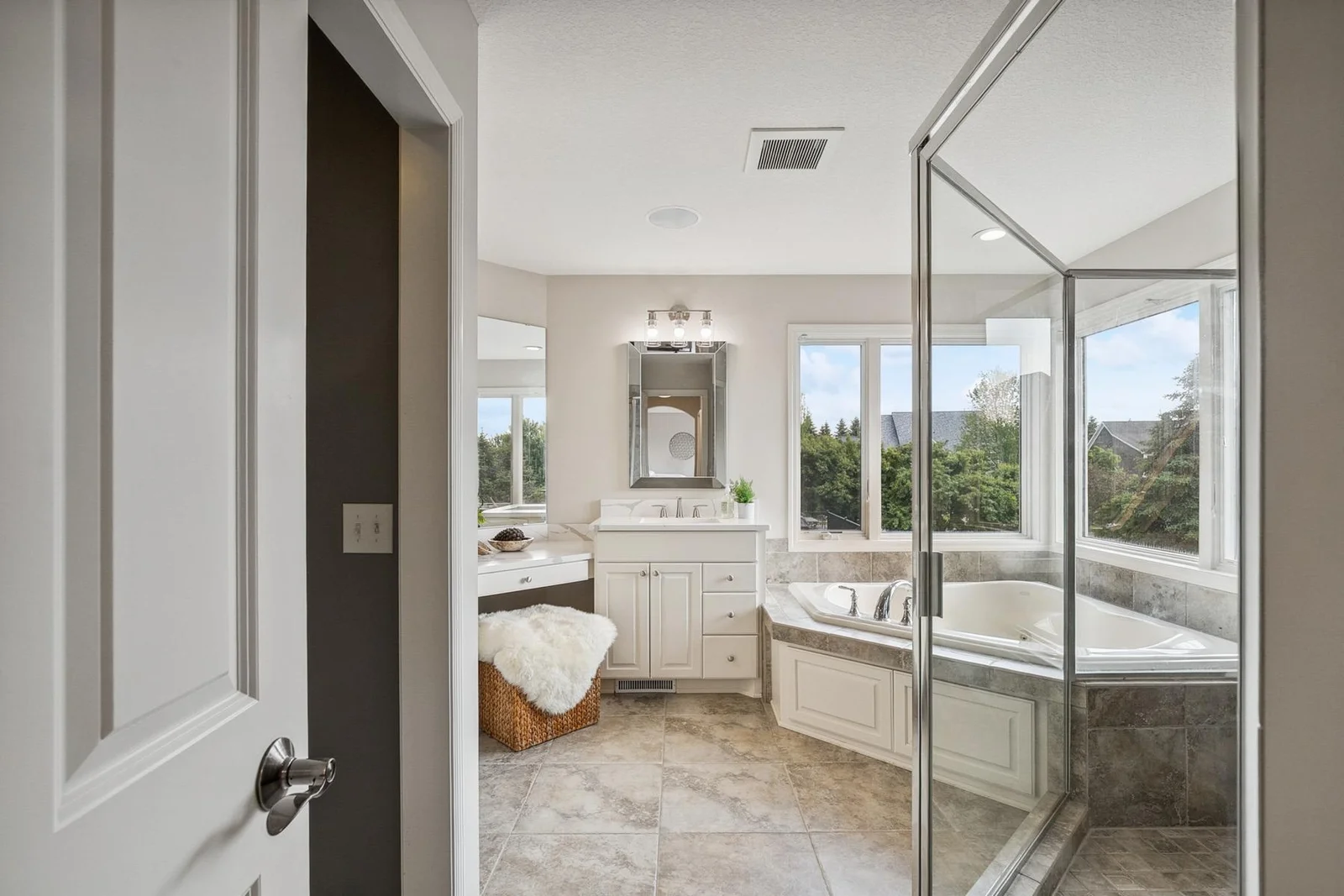 Luxurious primary bathroom featuring dual vanities and elegant finishes for a spa-like experience.