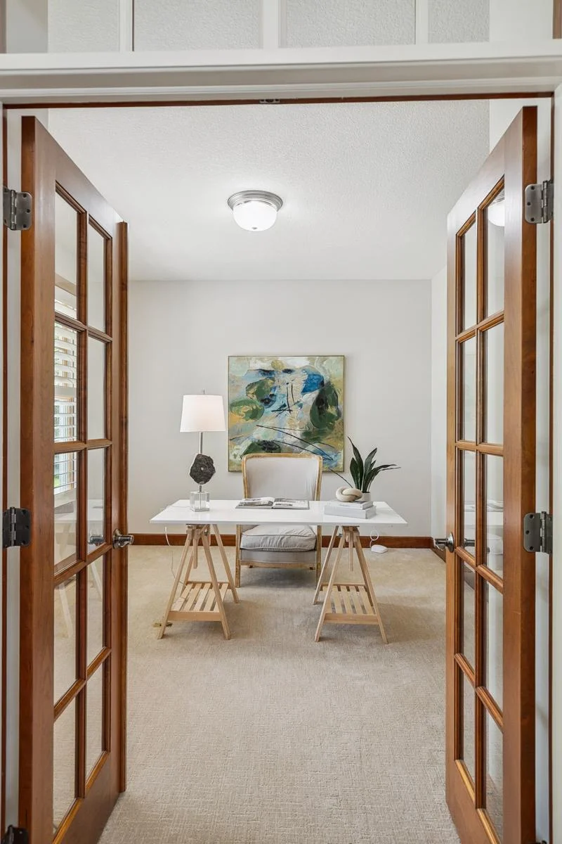 Stunning front office with custom cherry wood built-ins—perfect for remote work or reading.