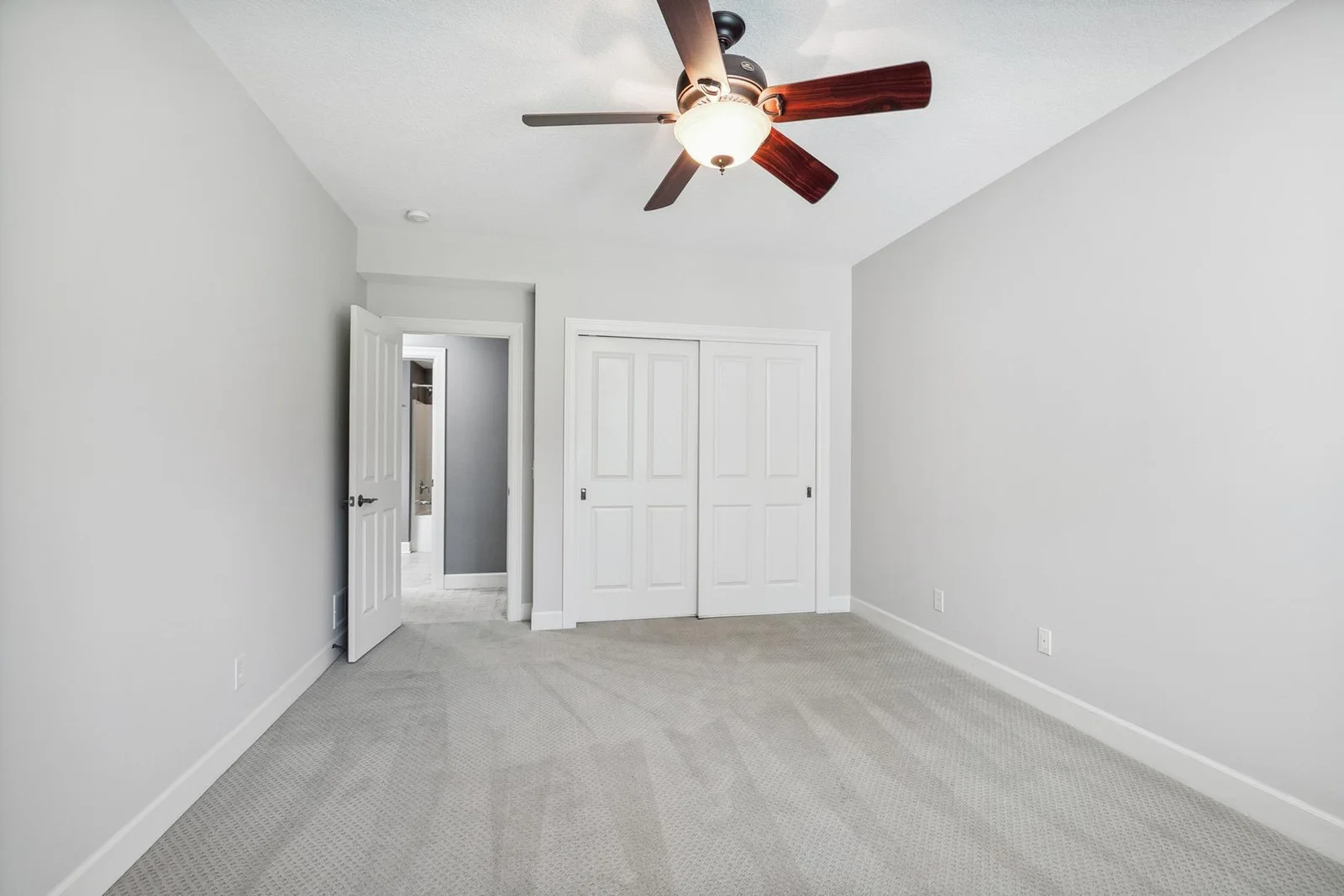 Versatile bedroom space on the lower level, perfect for workouts, guests, or a private office.