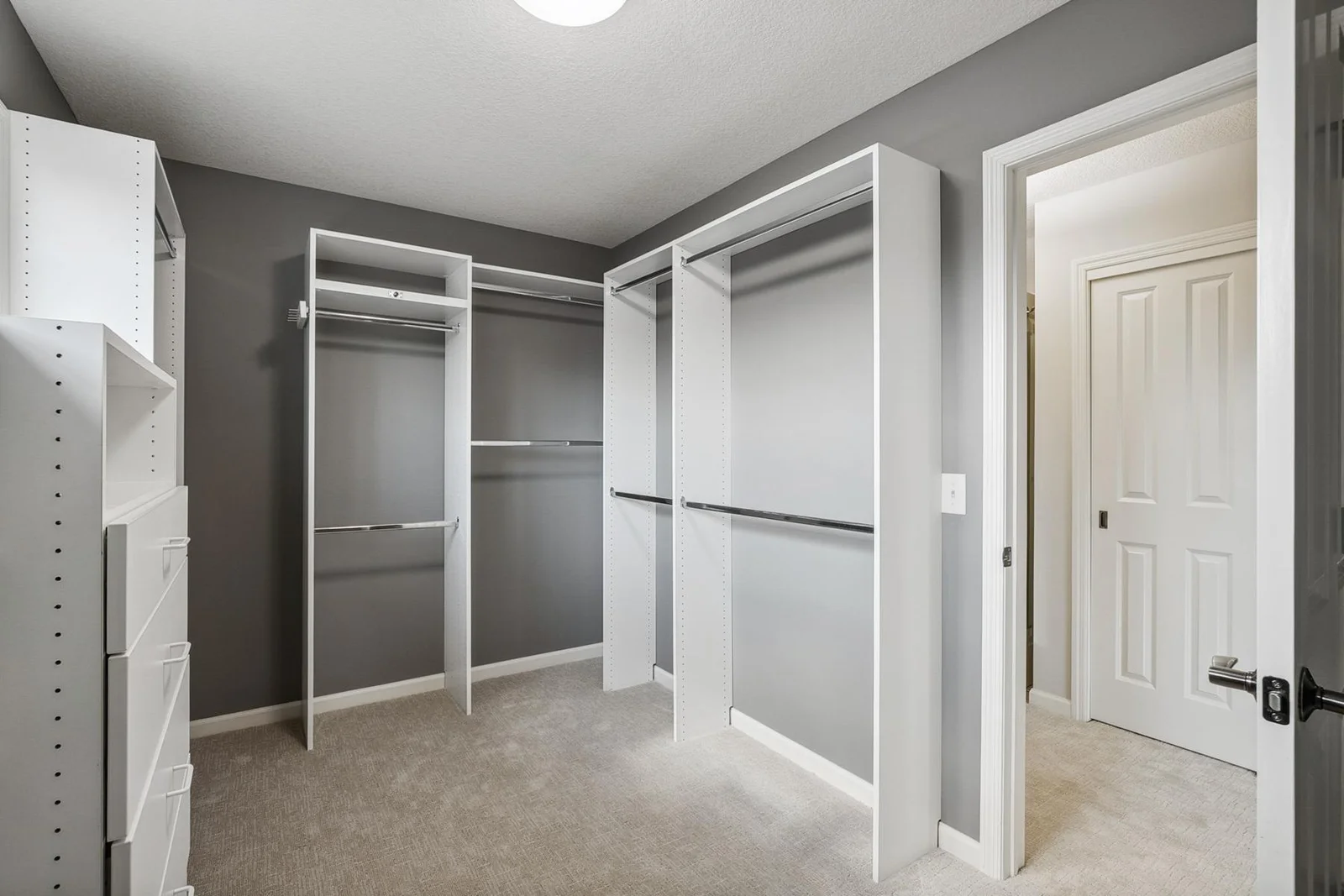 Easy access to the expansive walk-in closet with built-in organizers for effortless storage.