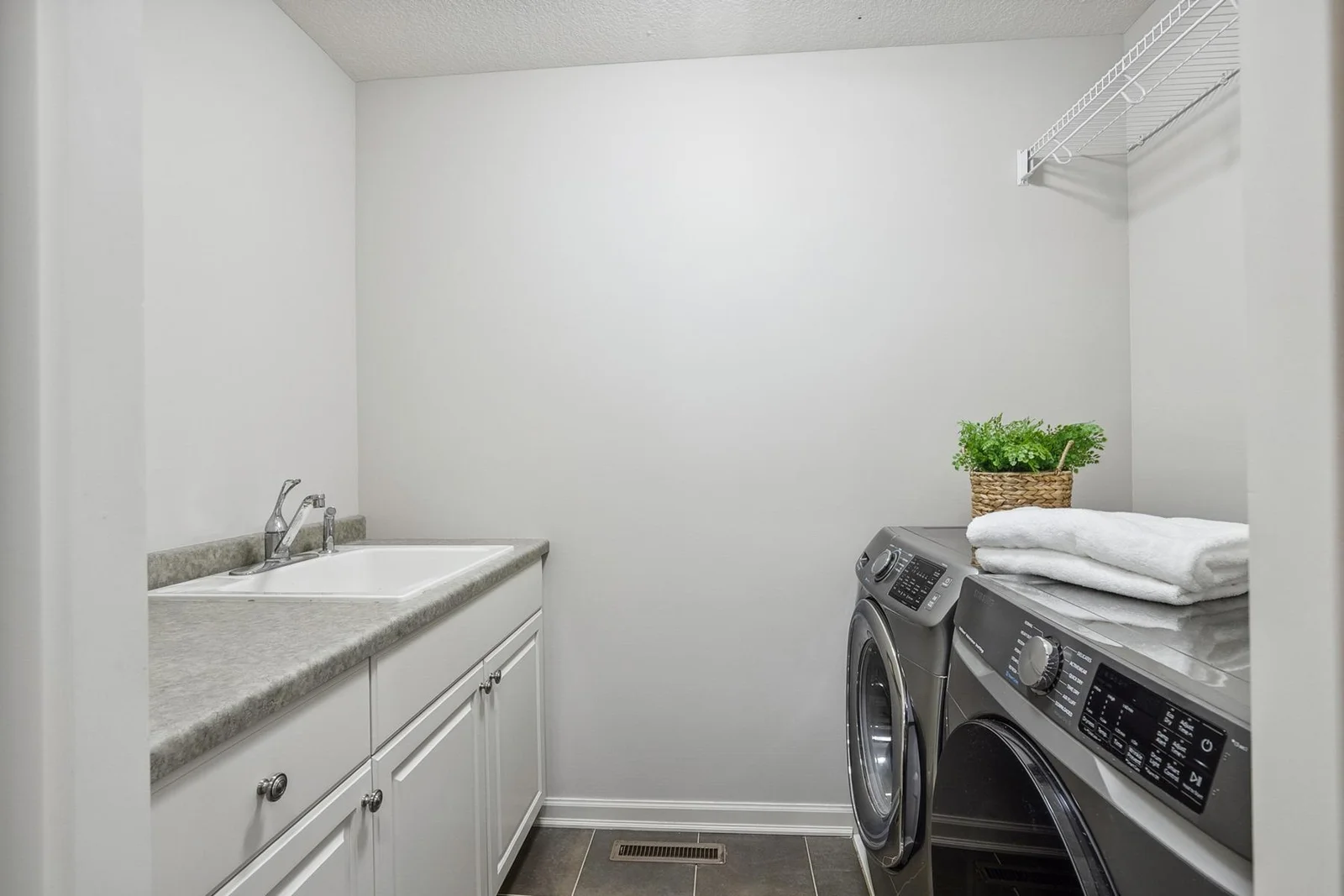 Convenient upper-level laundry room designed for easy, efficient daily living.