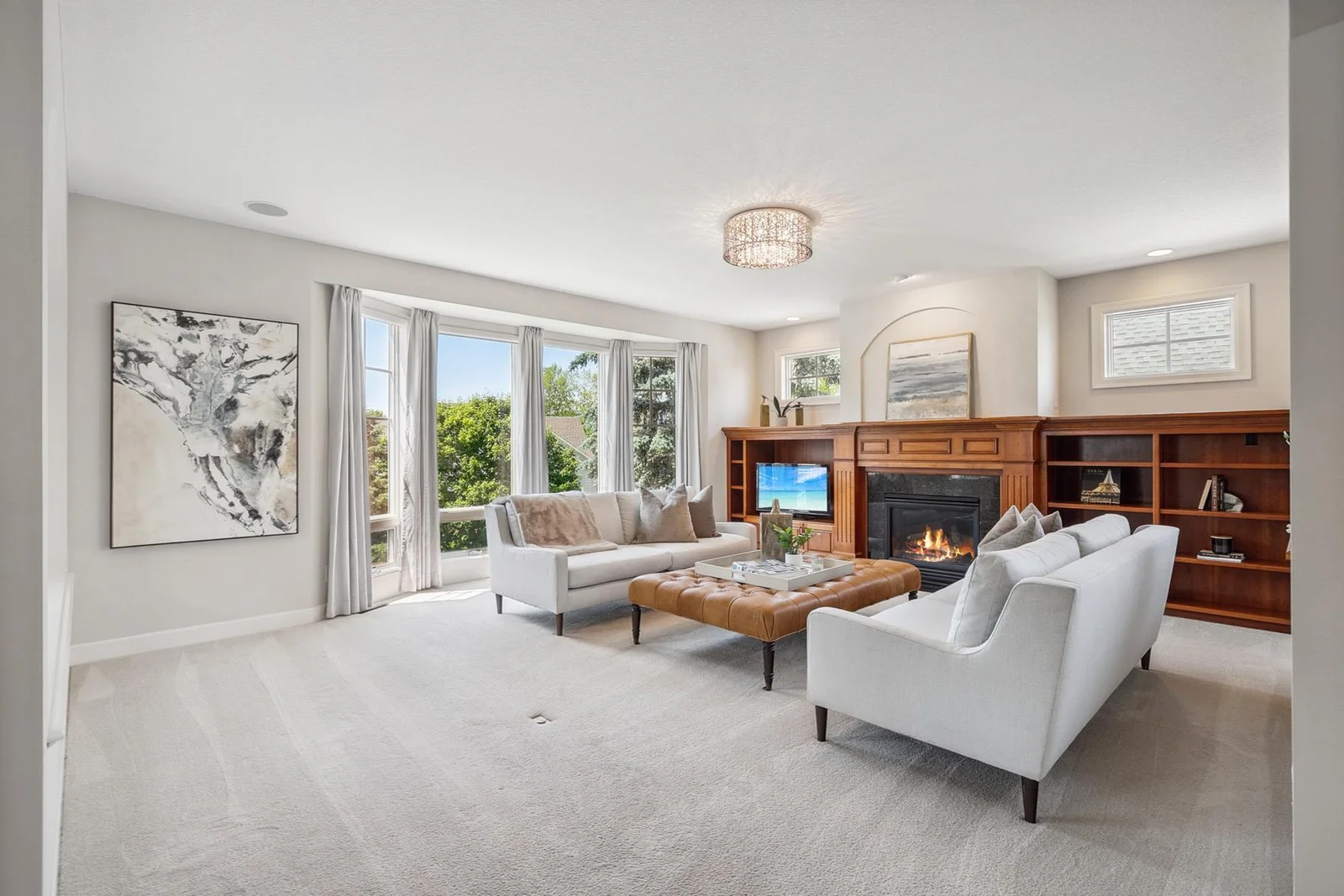 Warm and inviting living room anchored by a cozy fireplace and elegant finishes.