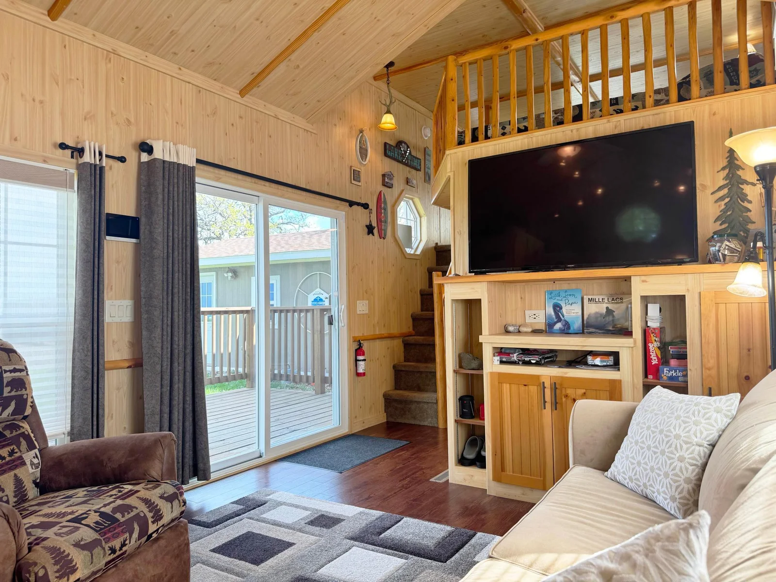 This cozy living room offers fantastic window and patio door lake views!