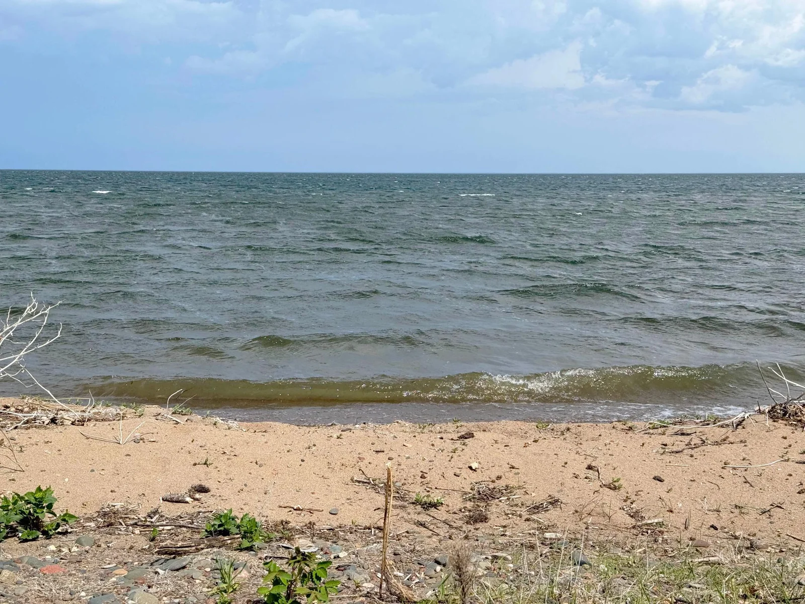 Doesn't get much better than this access to 100' of sandy beach! Great for swimming; you can walk out pretty far and no weeds! Bonus - big bass fishing right off the dock!!
