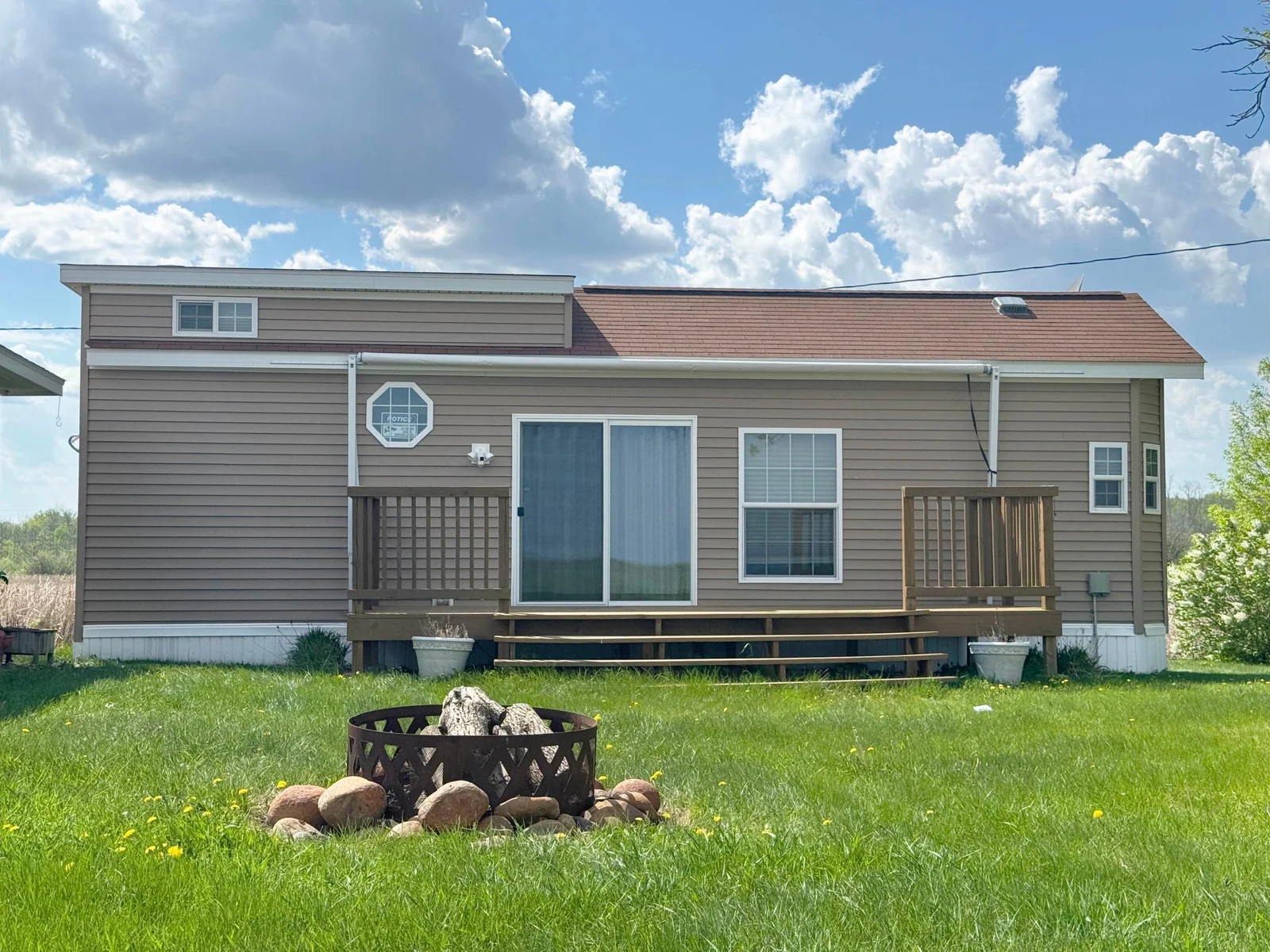 This 2013 park model is simply spotless & conveniently located just 2 miles S. of Garrison; picture yourself with your morning coffee or evening beverage under this charming covered deck watching spectacular sunrises & sunsets moving across the lake!