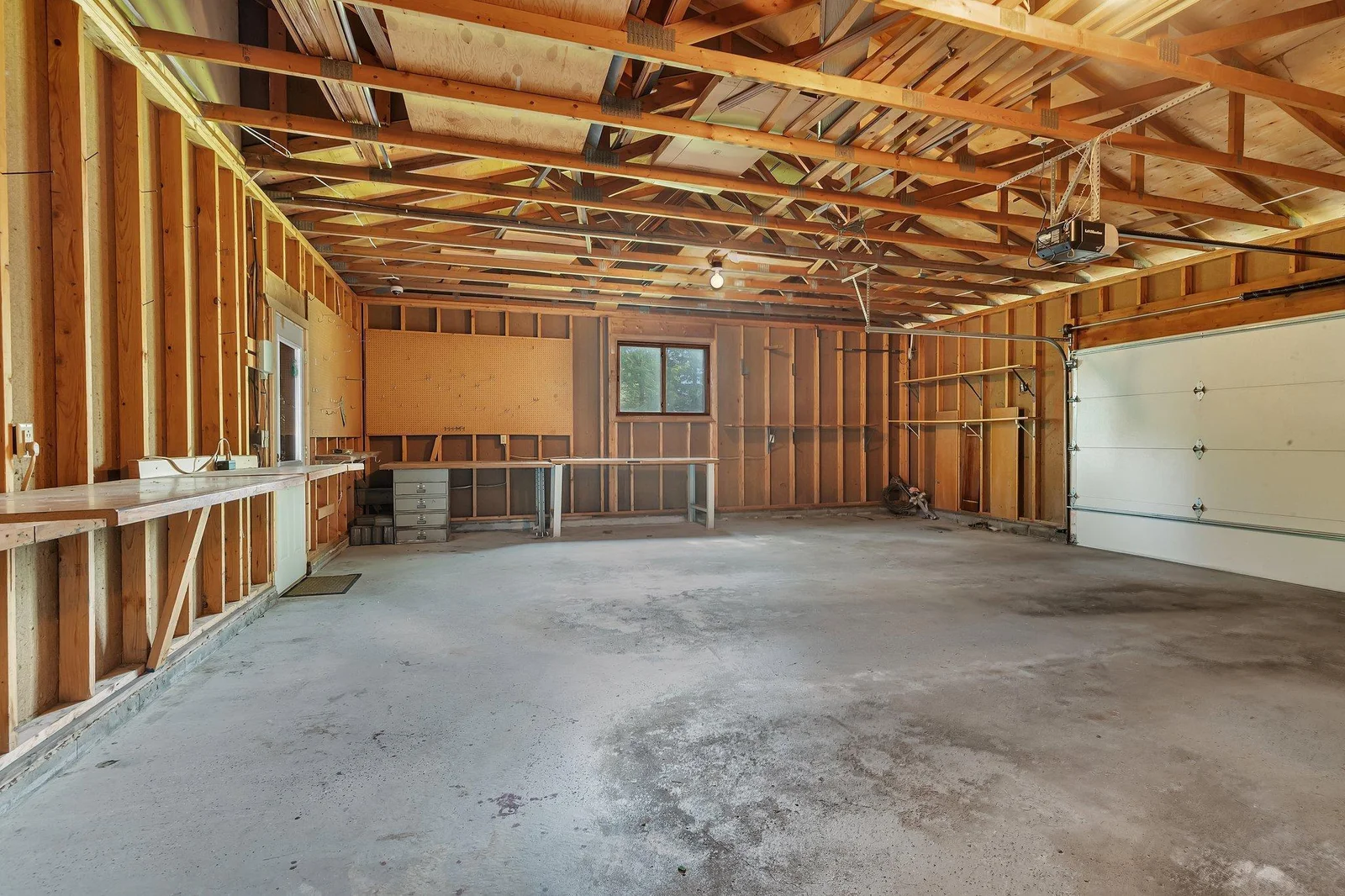 Side facing oversized 2 stall attached garage with access to back patio