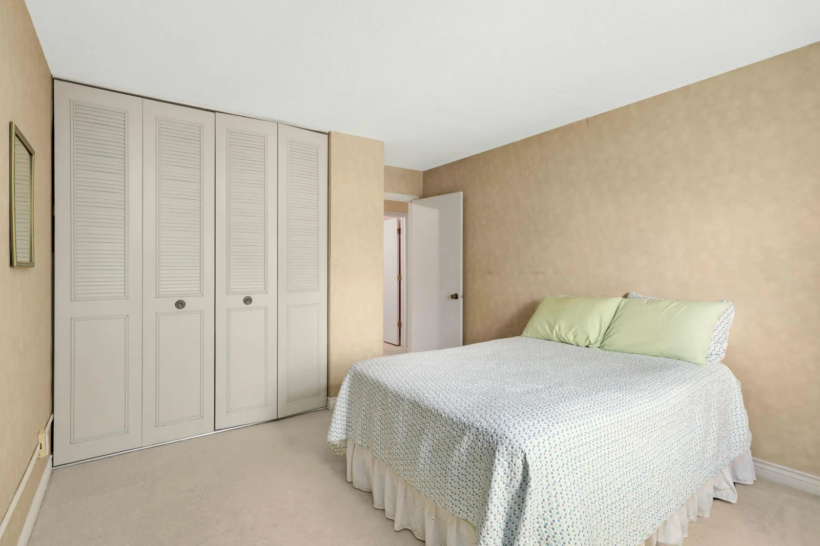 Bedroom two with full wall of closets.