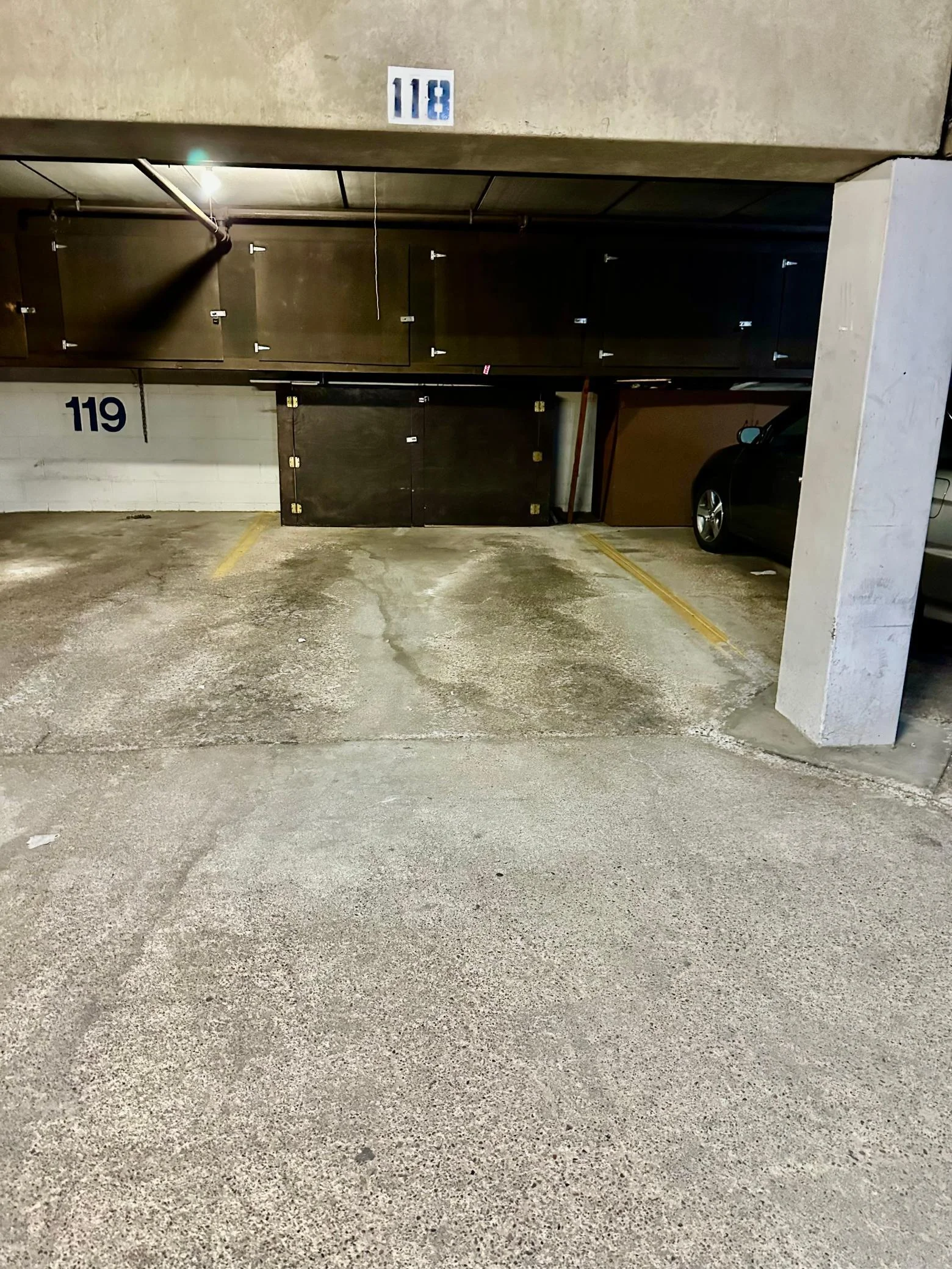 Assigned parking spot 118 includes storage cabinets.