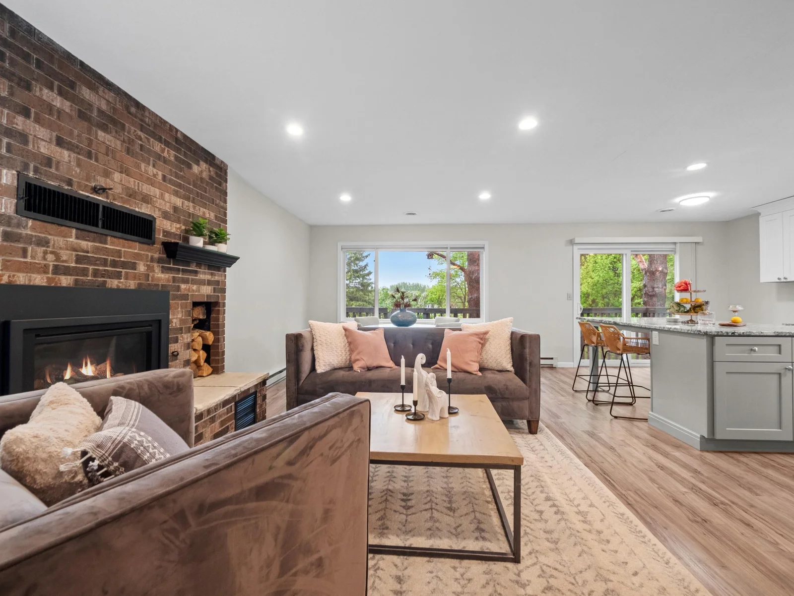 The living room is centered around a cozy fireplace, adding warmth and comfort to the space.