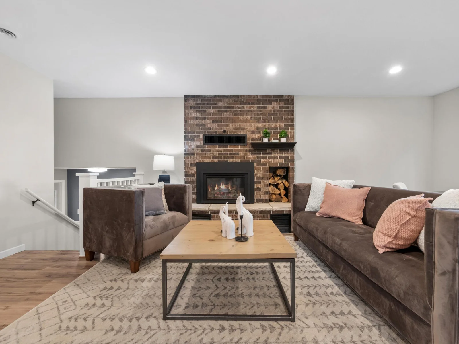 A brick fireplace creates a rustic yet elegant centerpiece for the room.