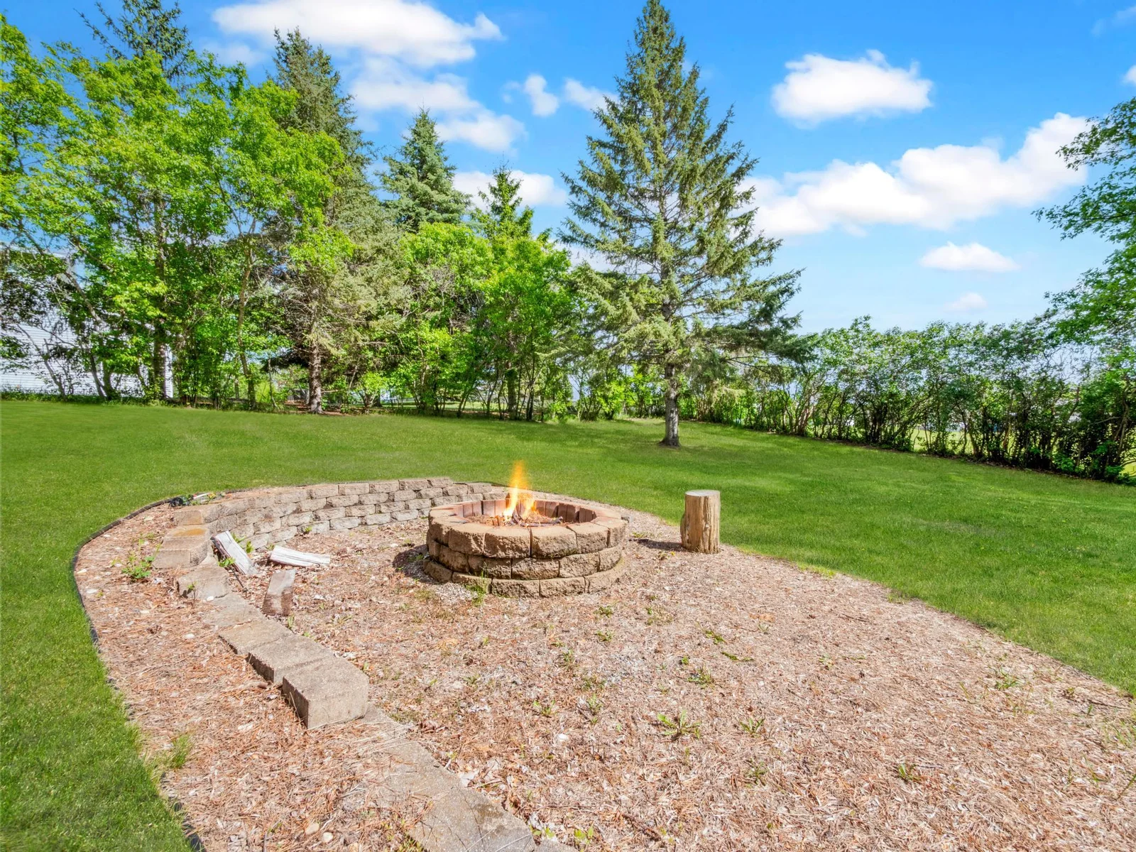 Gather around the bonfire in your spacious yard for a cozy evening filled with warmth, laughter, and starry skies.