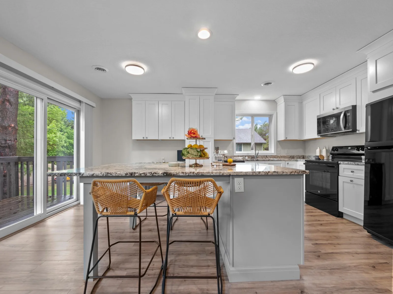 An expansive kitchen island provides casual seating along with extra storage and prep space.