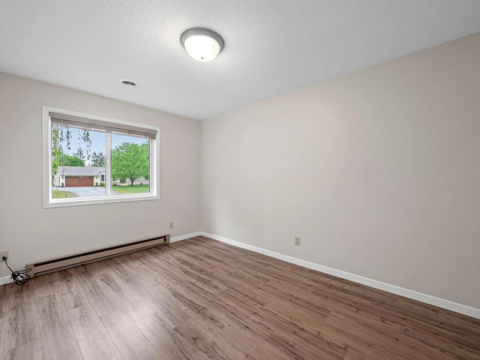 The second upper level bedroom is conveniently located near the primary bedroom, ideal for keeping loved ones close.