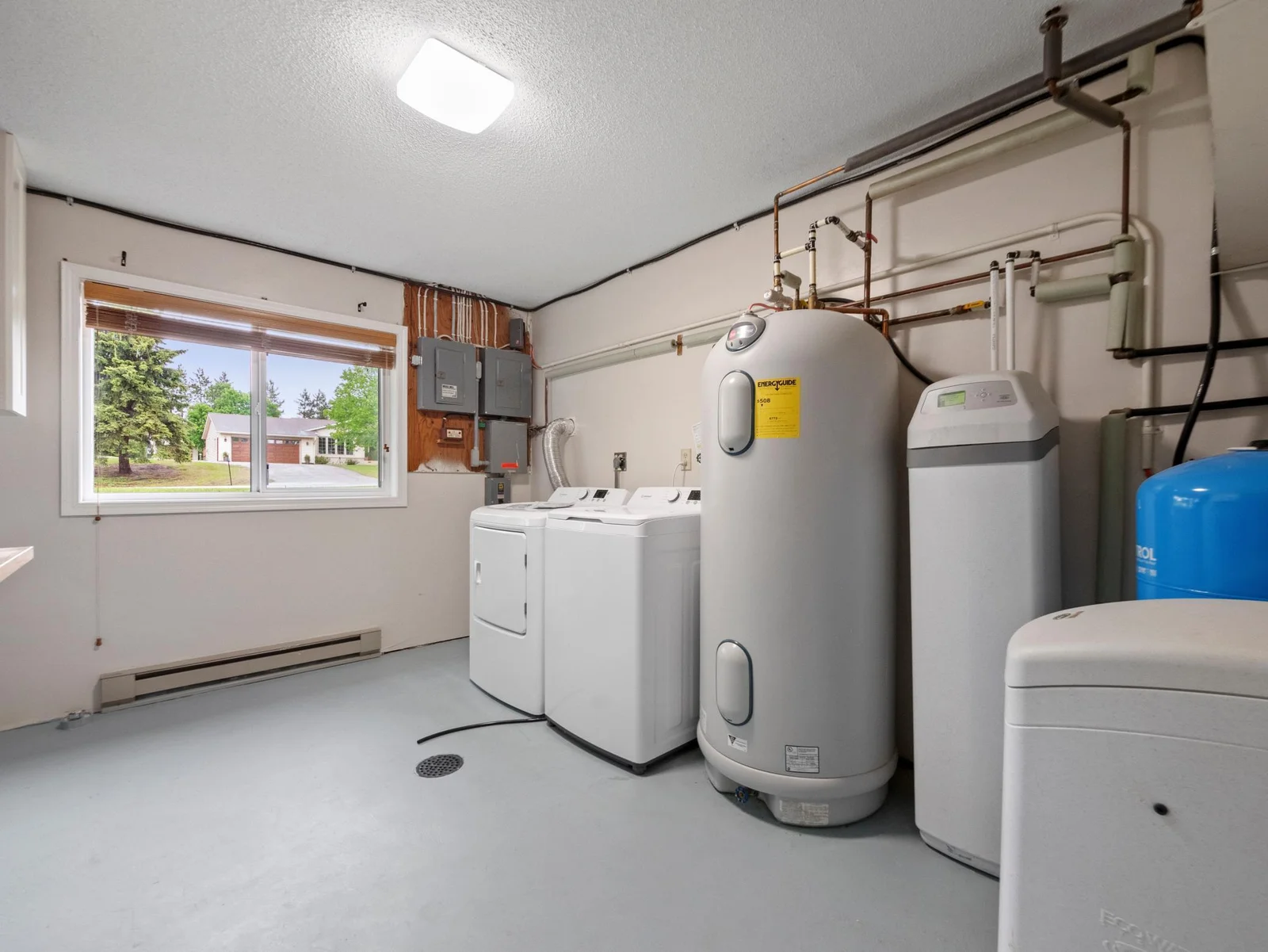 A clean, large laundry room with ample storage for all your essentials.