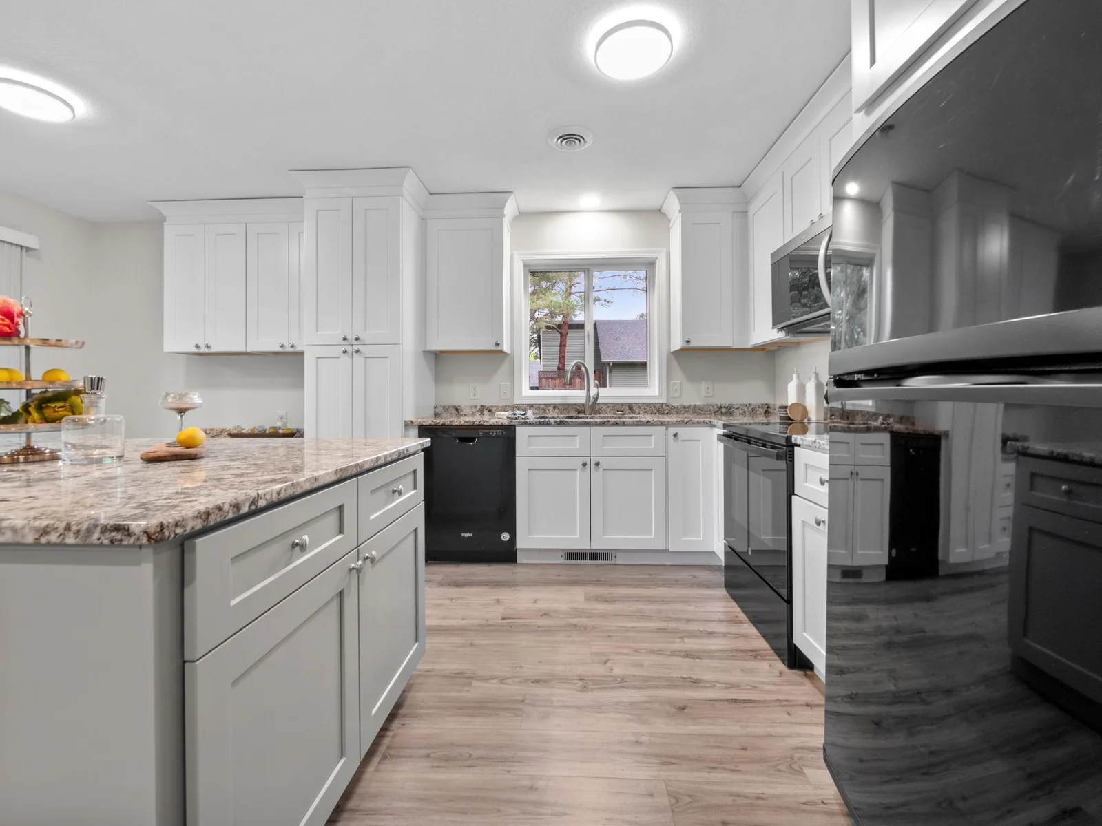 The kitchen is a showstopper with new modern cabinetry, sleek hard surface countertops, and stylish hardware.