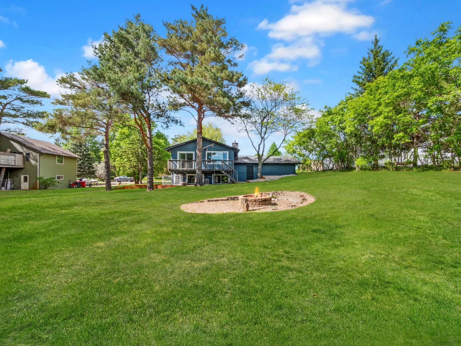 A spacious backyard retreat complete with a fire pit, perfect for relaxing evenings and outdoor gatherings.