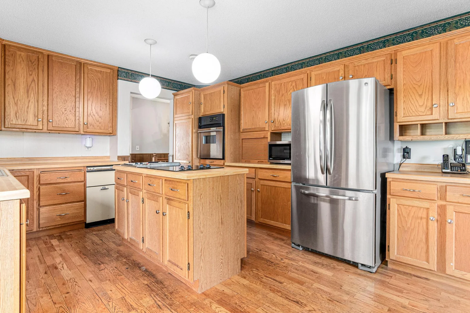 Alternate view of kitchen back toward the foyer.
